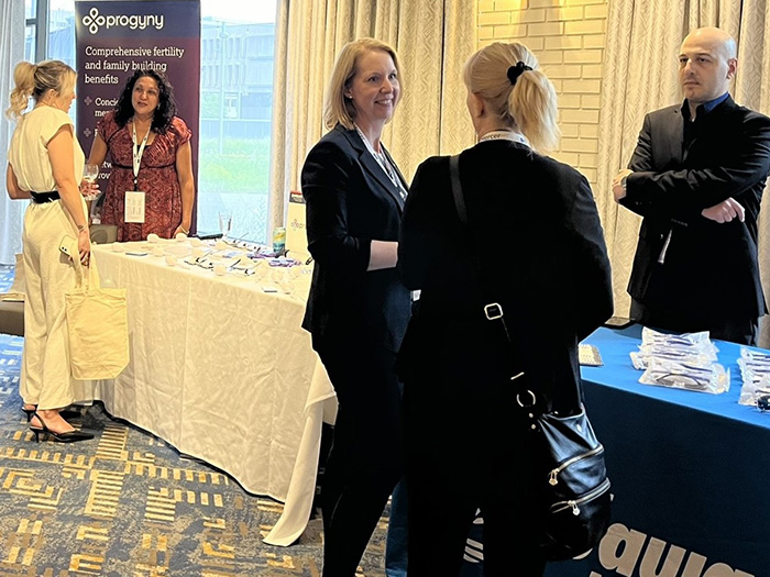 People visiting an exhibitor booth