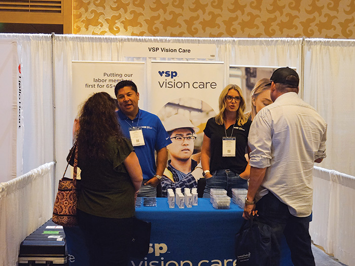 People visiting an exhibitor booth