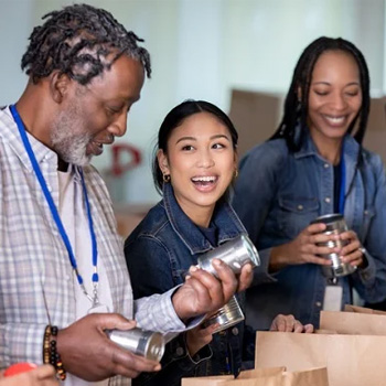 diverse group of volunteers packaging goods. 