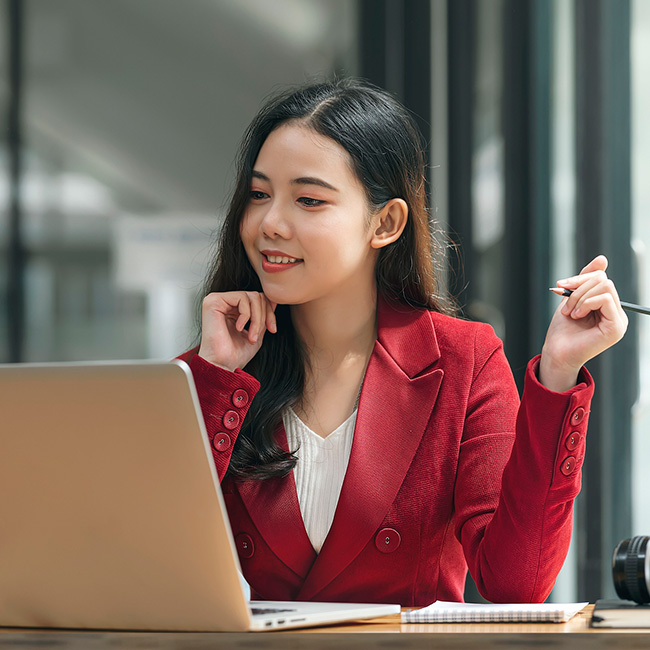 Woman working with a laptop and notepad