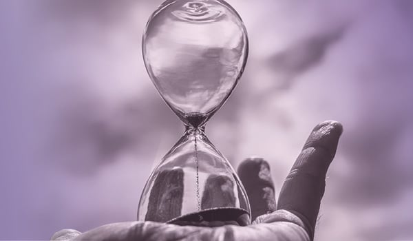 An hourglass resting in the palm of a hand