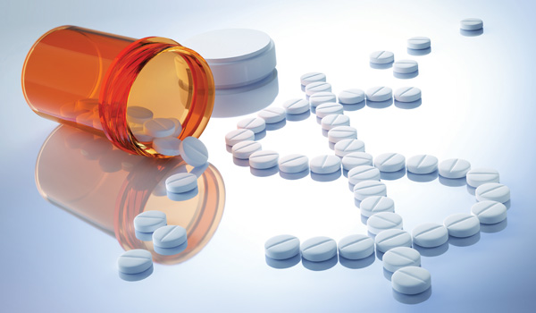 Pills spilling out of a pill bottle, forming a dollar sign