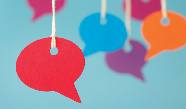 Cut outs of chat bubbles hanging from strings