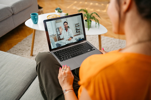 Woman having a doctor's appointment online at home